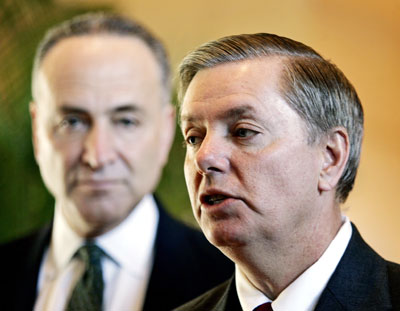 U.S. Senators South Carolina Republican Lindsey Graham (R) and Charles Schumer, a New York Democrat, talk to the media at a hotel lobby in Beijing March 22, 2006. A U.S. senator threatening sanctions unless China revalues the yuan said he wanted to learn whether there was "a pattern of progress" in the currency's quickening rate of climb. Schumer is co-author with Graham of a bill that would impose a tariff of 27.5 percent on Chinese imports into the United States unless Beijing revalues the yuan "at or near its fair market value."