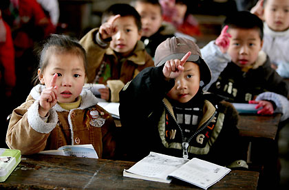 Chinese children attend a class at a primary school in China's rural Panghai town, Guizhou Province March 1, 2006. Spending on education is expected to take up a record 4 per cent of China's gross domestic product (GDP) during the coming five years