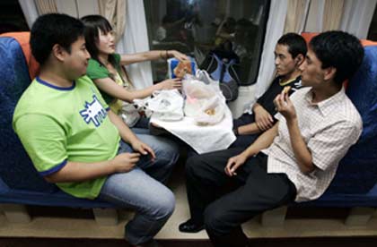 Passengers chat on board the first Beijing-to-Lhasa train moments before it leaves the Beijing railway station July 1, 2006. 