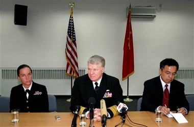 The commander of the U.S. Pacific Fleet Adm. Gary Roughead speaks to the media in Beijing, China, Monday, Nov. 13, 2006. Adm. Roughead began a visit to China on Monday in a trip aimed at strengthening ties between the two navies and gaining insight into the Asian power's military buildup. A man at right and woman at left are not identified. (AP