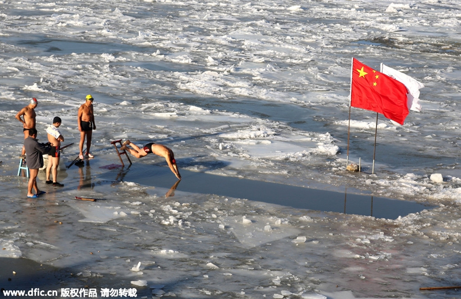 Swimmers battle against the cold in ice-covered river