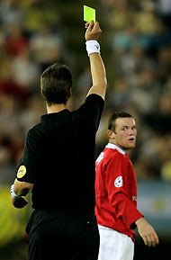 Manchester United's Wayne Rooney reacts to referee Kim Milton Nielson after receiving a second yellow card during his team's Champions League Group D match against Villarreal at the Madrigal Stadium in Villarreal, Spain September 14, 2005.