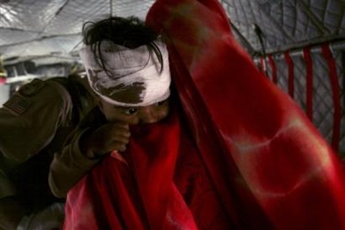 A wounded boy is taken into a U.S. helicopter in Balakot, Pakistan, Saturday Oct. 15, 2005.