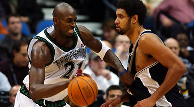 Minnesota Timberwolves forward Kevin Garnett (21) drives against San Antonio Spurs forward Tim Duncan (R) during the second half of their NBA game in the Target Center in Minneapolis, December 15, 2005.