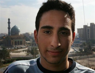 Farris Hassan, a 16-year-old-teen from Fort Lauderdale. Fla., poses for a portrait at a hotel, backdropped by the Ramadan 14th mosque in Baghdad, Iraq, Wednesday Dec. 28, 2005.