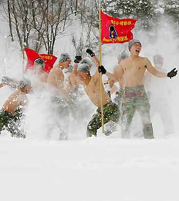 South Korean marines react during an annual severe winter season drill, to improve combat abilities in the cold weather and heavy snowfall, in Pyongchang, about 180km (113 miles) east of Seoul February 8, 2006.