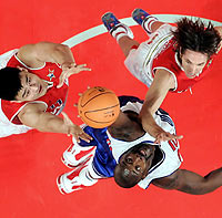 Western Conference center Yao Ming (L) and guard Steve Nash (R) battle Eastern Conference center Shaquille O'Neal for a rebound during first half action at the 55th NBA All-Star Game in Houston, Texas, February 19, 2006.