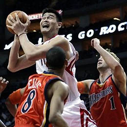 Houston Rockets center Yao Ming (11) goes above Golden State Warriors defenders Monta Ellis (8) and Troy Murphy (1) for two points in the first half in NBA basketball action Friday, Feb. 24, 2006, in Houston.