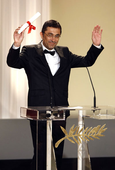 Turkish director Nuri Bilge Ceylan holds his Best Director award for his film 