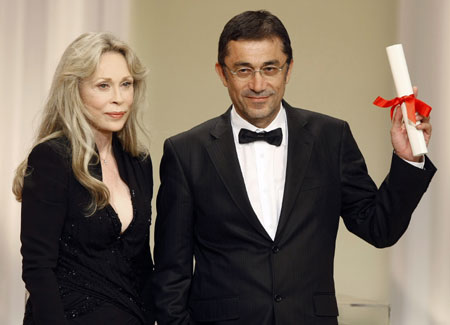 Turkish director Nuri Bilge Ceylan holds his Best Director award for his film 