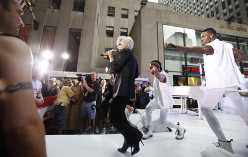 Lady Gaga performs during a rain shower on NBC's 
