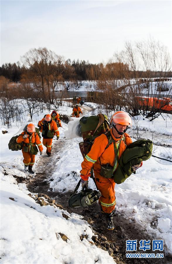 Firefighters withdraw from snow-covered forest