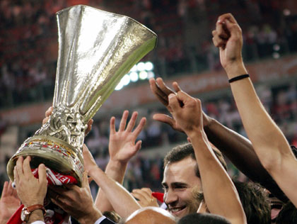 Spanish Crown Prince Felipe stands amid Sevilla players as they lift the UEFA Cup trophy following their 4-0 victory against Middlesbrough in the UEFA Cup soccer final in Eindhoven, Netherlands, May 10, 2006. 