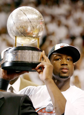 Miami Heat guard Dwyane Wade holds the Eastern Conference trophy after the Heat defeated the Detroit Pistons in Game 6 of the NBA Eastern Conference Finals in Miami June 2, 2006. Miami won the game 95-78 and the series 4-2 to advance to the NBA finals.
