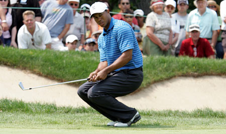 Golfer Tiger Woods reacts to missing a birdie chip on the fourth hole during the first round of the Western Open in Lemont, Illinois, July 6, 2006. 