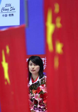 Olympic gold medalist Guo Jingjing reacts during a flag-raising ceremony as she won the gold at women's one-meter sprint board competition at 15th World Cup in Changshu, China's east Jiangsu Province on July 19, 2005. [Xinhua]