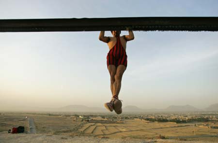 A young Afghan wrestler exercises on a hilltop in Kabul August 3, 2006.[Reuters]