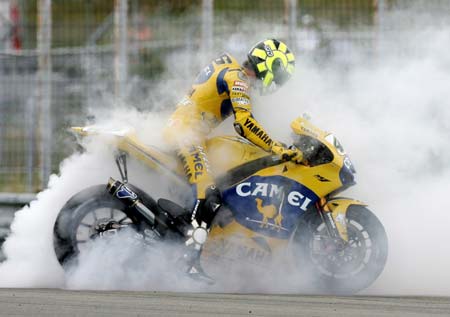 Yamaha's MotoGP rider Valentino Rossi of Italy smokes his wheels after the Czech Grand Prix at Masaryk's circuit in Brno August 20, 2006.