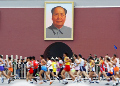 Competitors run in front of a portrait of former Chinese leader Mao Zedong at the Tiananmen Gate during the 2006 Beijing International Marathon in Beijing October 15, 2006. The annual Beijing International Marathon is organized by the Chinese Athletics Association and was first held in 1981.