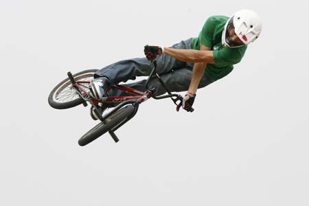 Ben Snowden of the U.S jumps with his bicycle during the opening day of Asia Extreme Games in Shanghai May 3, 2007. 