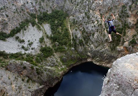 Base jumper Nenad Pesut, of Croatia, jumps from a 250 metre (820 feet) high cliff, near the southern town of Imotski, May 24, 2007. Pesut was one of 6 international base jumpers who jumped into Red Lake without a permit from Croatian authorities.