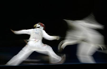 Mariana Gonzalez (L) of Venezuela fences against Misleydis Compani of Cuba during their women's individual foil fencing semi-final match at the Pan American Games in Rio de Janiero July 15, 2007. Gonzalez won the gold medal and Compani won the bronze medal. 