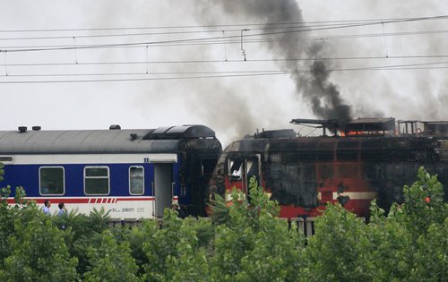 Moving passenger train catches fire in E. China