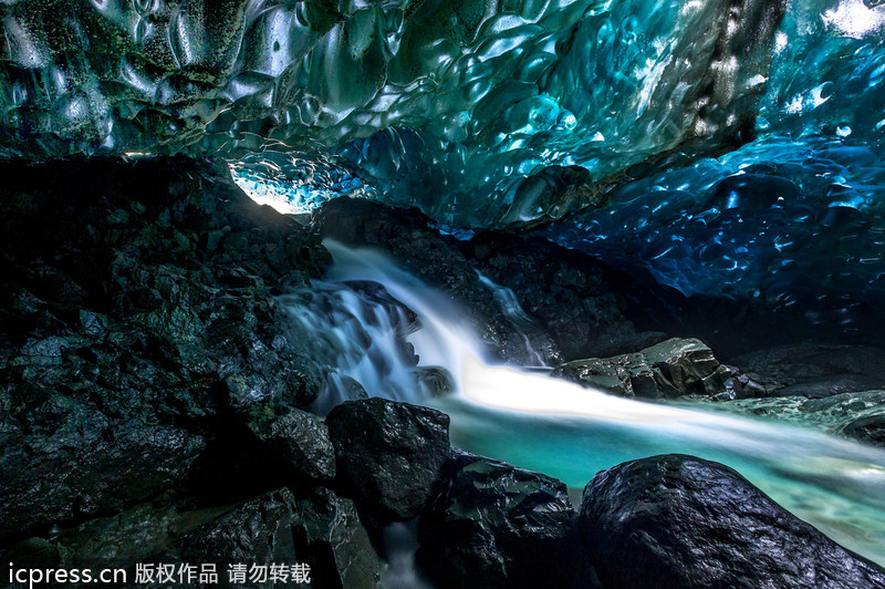 Amazing waterfall falls through ice caves