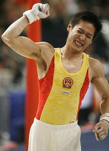 China's Feng Jing celebrates following his competition at the horizontal bar in the men's team final at the 39th Artistic Gymnastics World Championships in Aarhus, Denmark, October 17, 2006. Team China won the gold medal on Tuesday followed by Russia's silver and Japan's bronze.