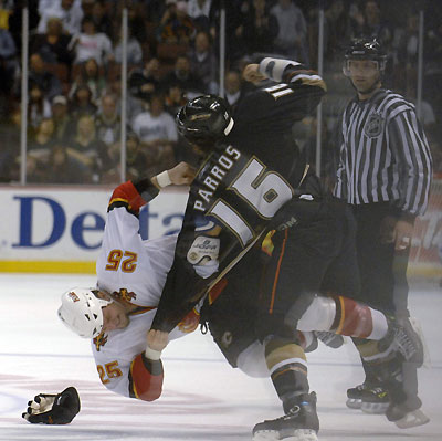 The Calgary Flames' Darren McCarty (L) and the Anaheim Ducks George Parros (R) fight during the first period of their NHL ice hockey game in Anaheim, California, November 26, 2006. 