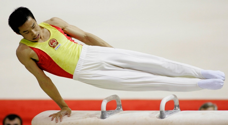 Chinese add three golds to double haul at gymnastics worlds
