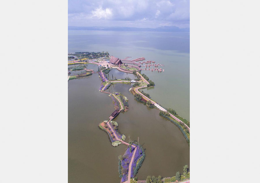Tourists go sightseeing at Gudian wetland park in Kunming