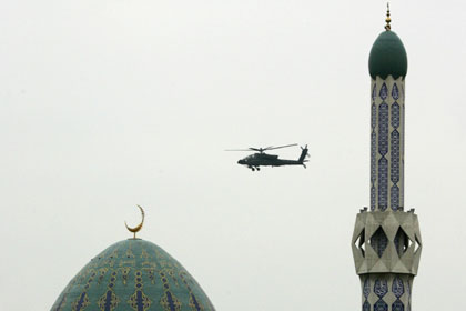 A U.S. helicopter hovers over Haifa Street in Baghdad January 9, 2007. U.S. fighter jets screamed over the city with unusual intensity and military helicopters were seeing hovering above Haifa Street, a stronghold of the Sunni Arab insurgency, witnesses said. 
