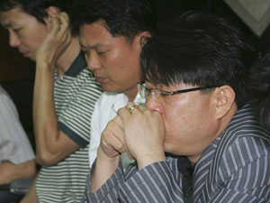 Family members of the kidnapped South Koreans in Afghanistan wait for television news about them in Seoul at around 1300 GMT, July 23, 2007. 