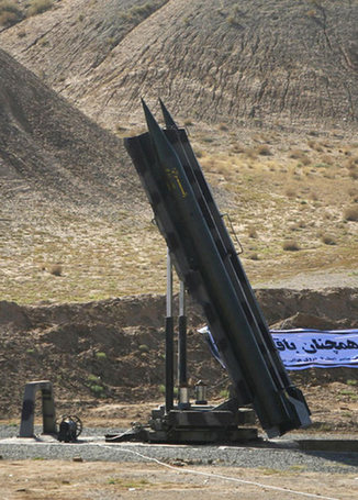 Under pressure for nukes, Iran test fires missiles