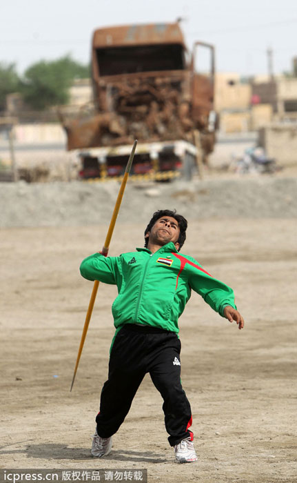 Iraqi paralympian Ahmed Naas throws his javelin during a practice session at an open field in his hometown of Batha, west of the Iraqi city of Nasiriyah, on Sept 22, 2012. Public sports in post-war Iraq